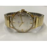 A GENTS 9CT GOLD CASED AVIA MANUAL WIND DATE WATCH WITH FLEXI STRAP IN ORIGINAL BOX