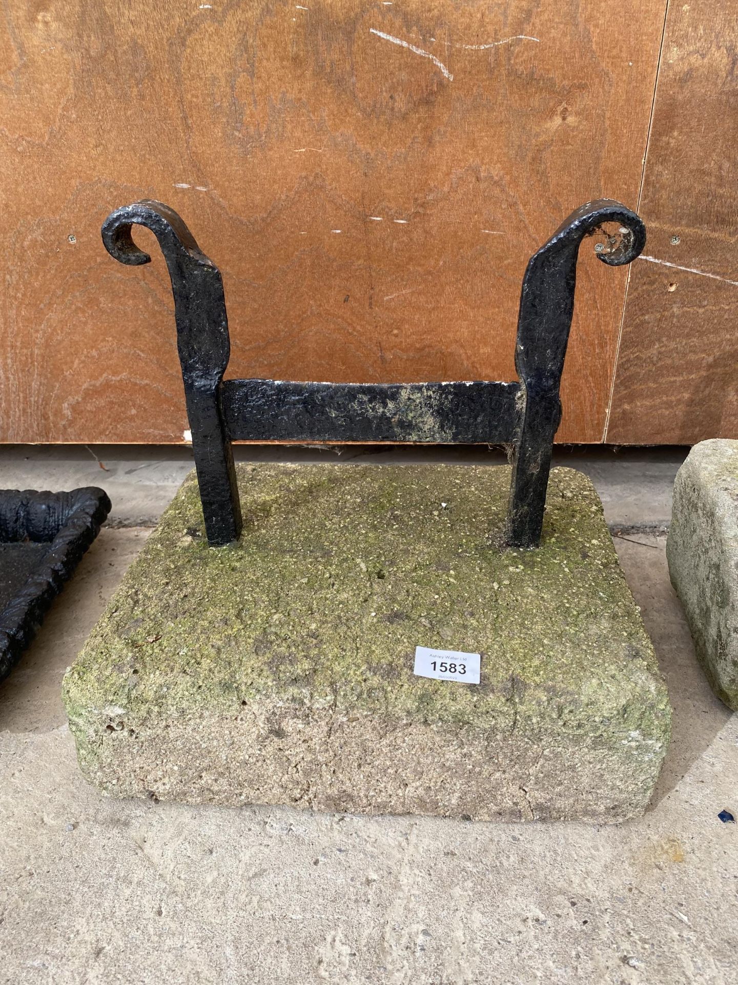 A METAL BOOT SCRAPER SET IN A PIECE OF YORK STONE