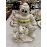 A CAST MODEL OF A MICHELIN MAN AND DOG HEIGHT 20CM