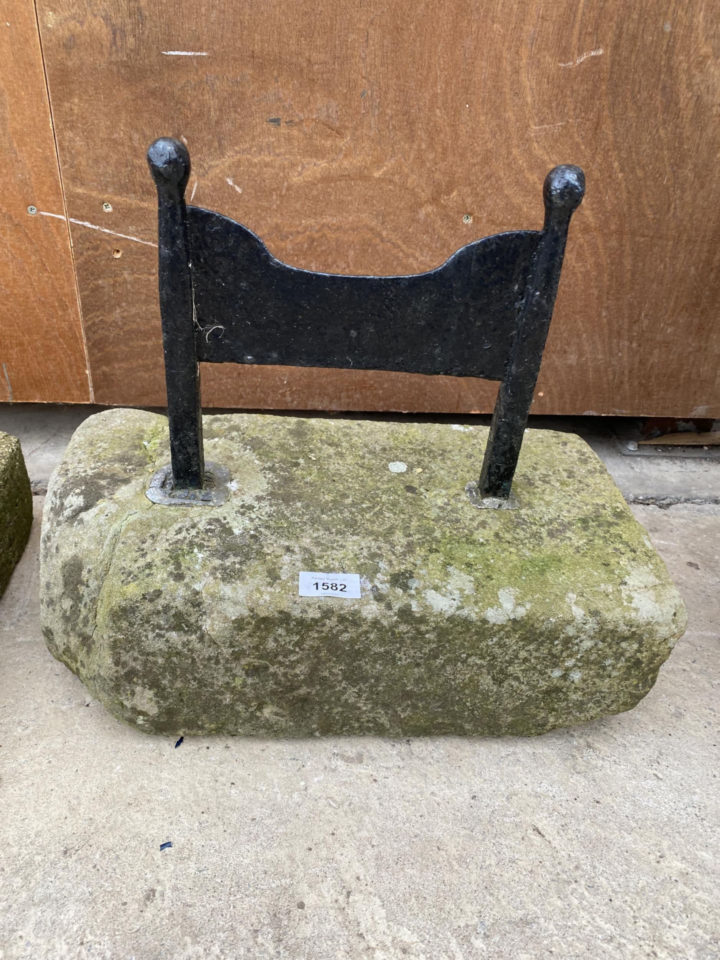 A METAL BOOT SCRAPER SET IN A PIECE OF YORK STONE