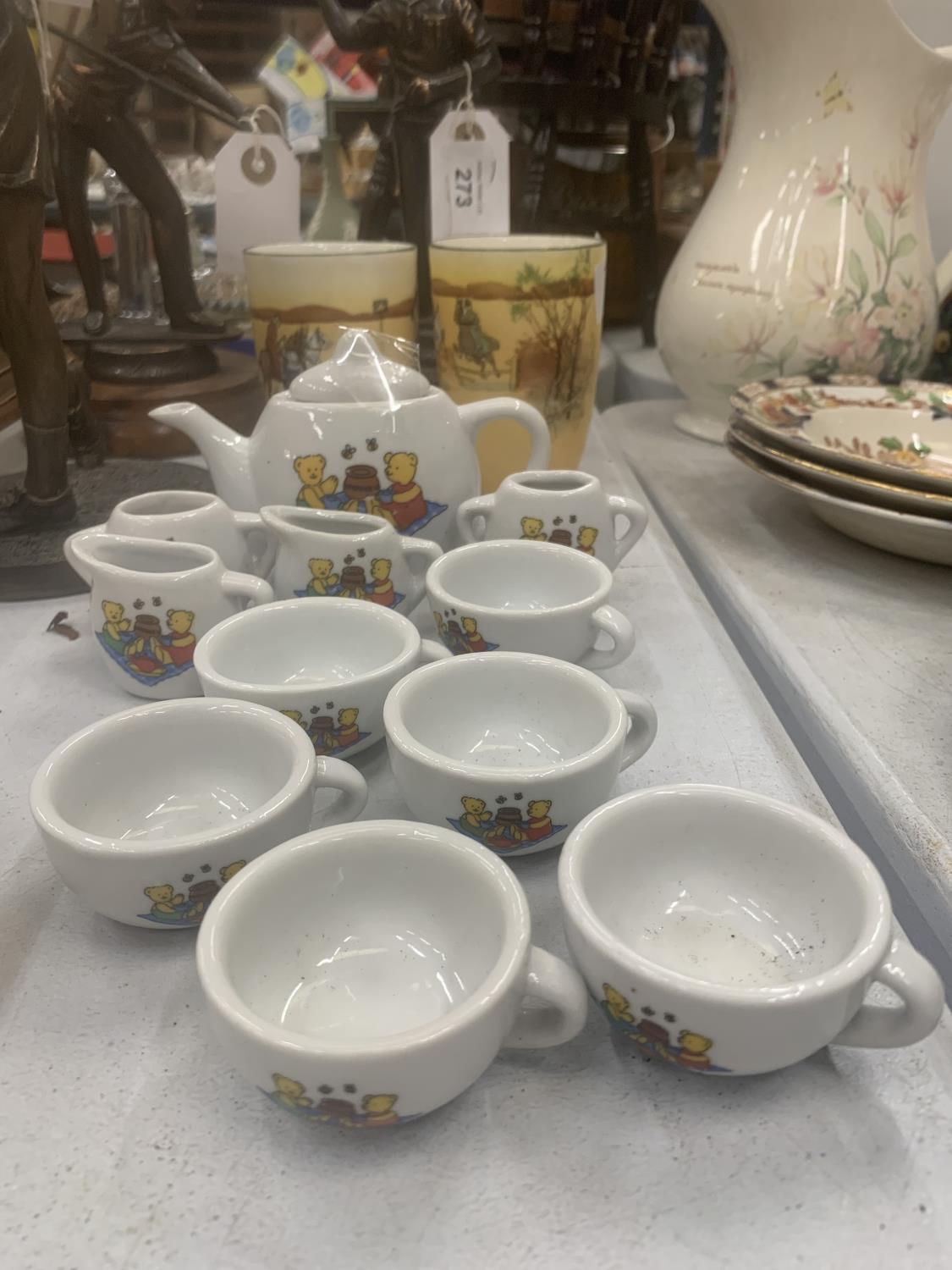 A MINIATURE CHILD'S POTTERY TEASET TO INCLUDE TEAPOT, JUGS, CUPS, ETC WITH A TEDDY BEARS PICNIC