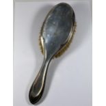 A CHESTER HALLMARKED SILVER BACKED CLOTHES BRUSH