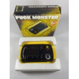 A BOXED RETRO CGL PUCK MONSTER ARCADE GAME