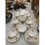 A ROYAL VALE TEASET WITH ROSE DECORATION TO INCLUDE A CAKE PLATE, CUPS, SAUCERS, SIDE PLATES,