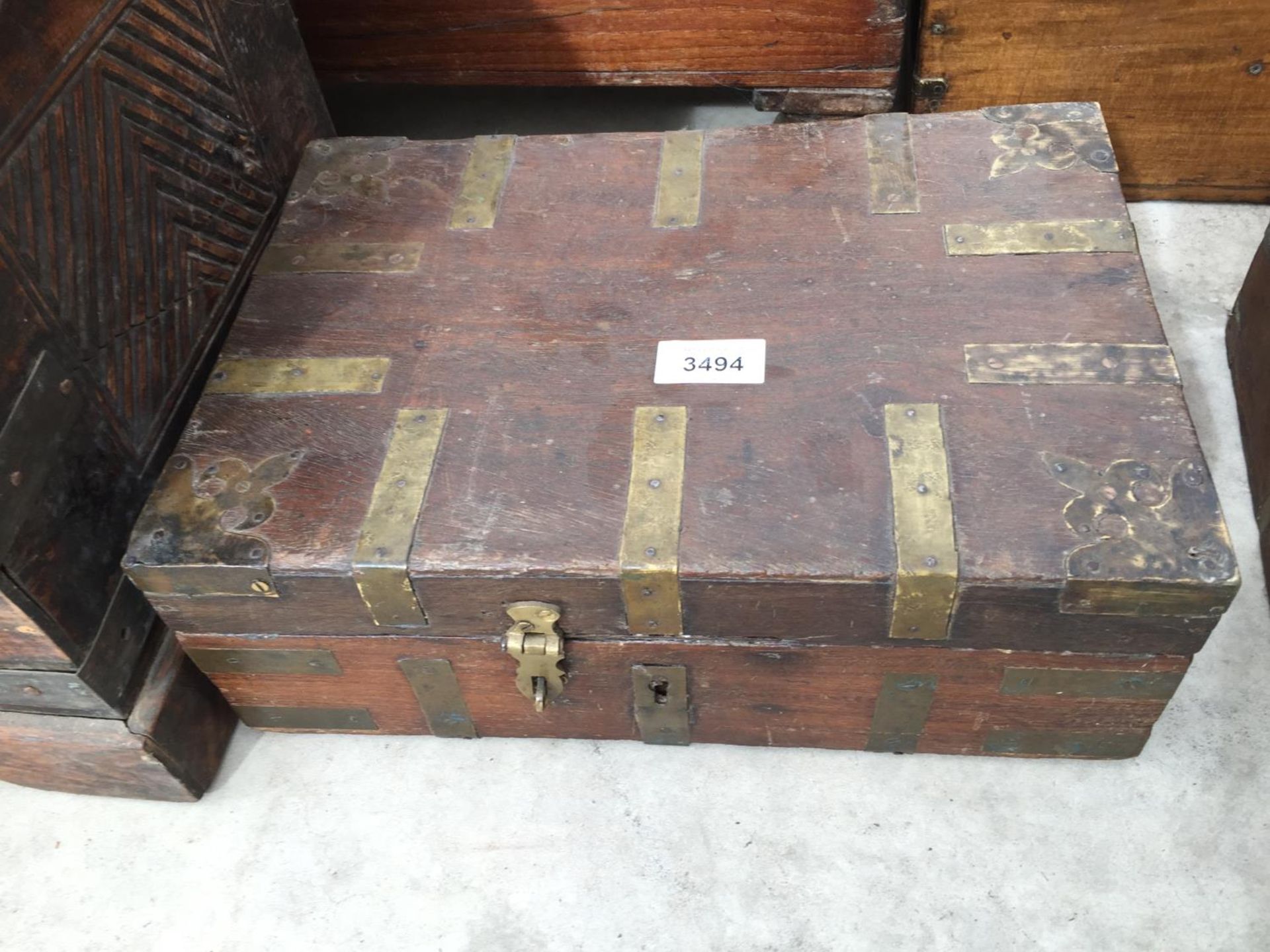 AN INDIAN HARDWOOD BOX WITH BRASS STRAPS, 13" WIDE