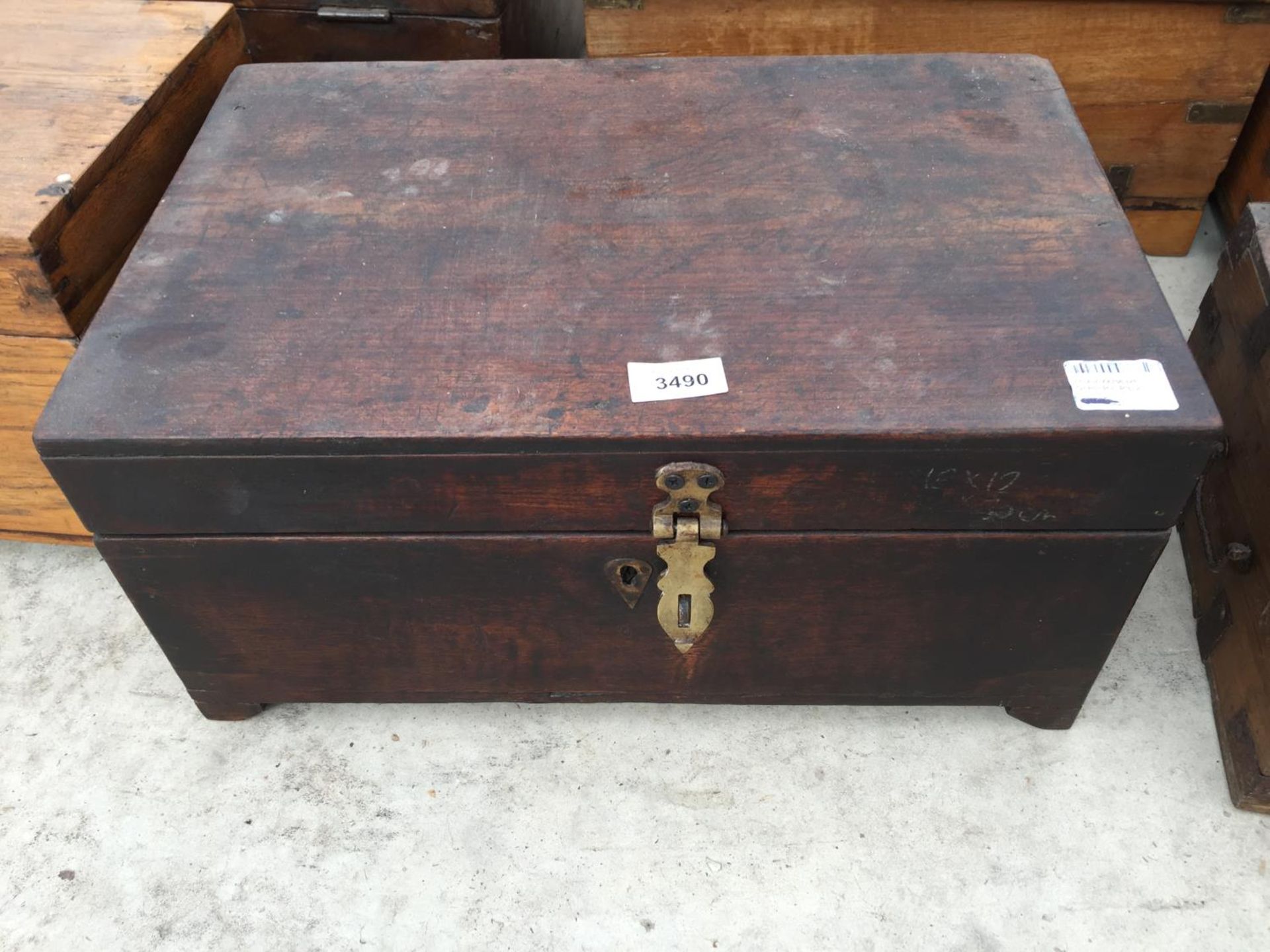 AN INDIAN HARDWOOD BOX WITH CAST IRON HANDLE, 18" WIDE