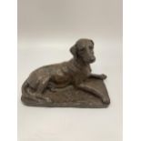 A DORIS LINDNER BRONZED RESIN MODEL OF A SEATED DOG, SIGNED TO REVERSE, LENGTH 20CM