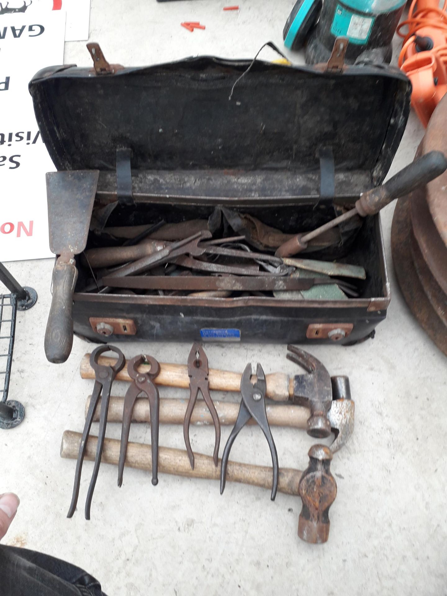 A TOOL BAG CONTAINING VARIOUS HAMMERS, SPANNERS, ETC
