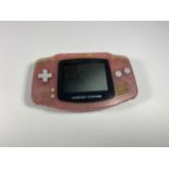 A PINK GAMEBOY ADVANCE CONSOLE