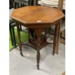 AN EDWARDIAN MAHOGANY OCTAGONAL TABLE WITH GALLERY BASE ON CASTORS