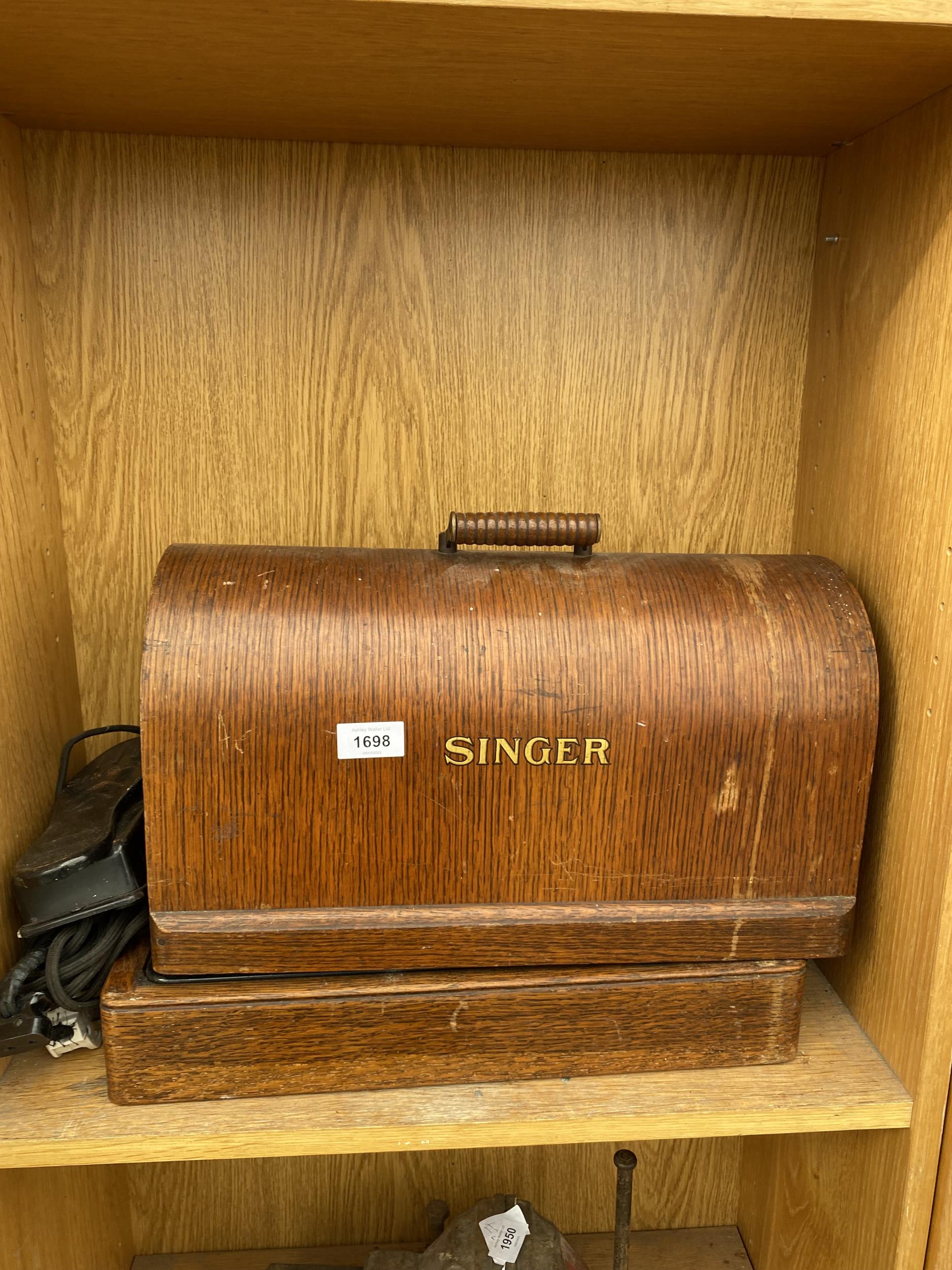 A VINTAGE SINGER SEWING MACHINE CONVERTED TO ELECTRIC AND WITH WOODEN CARRY CASE