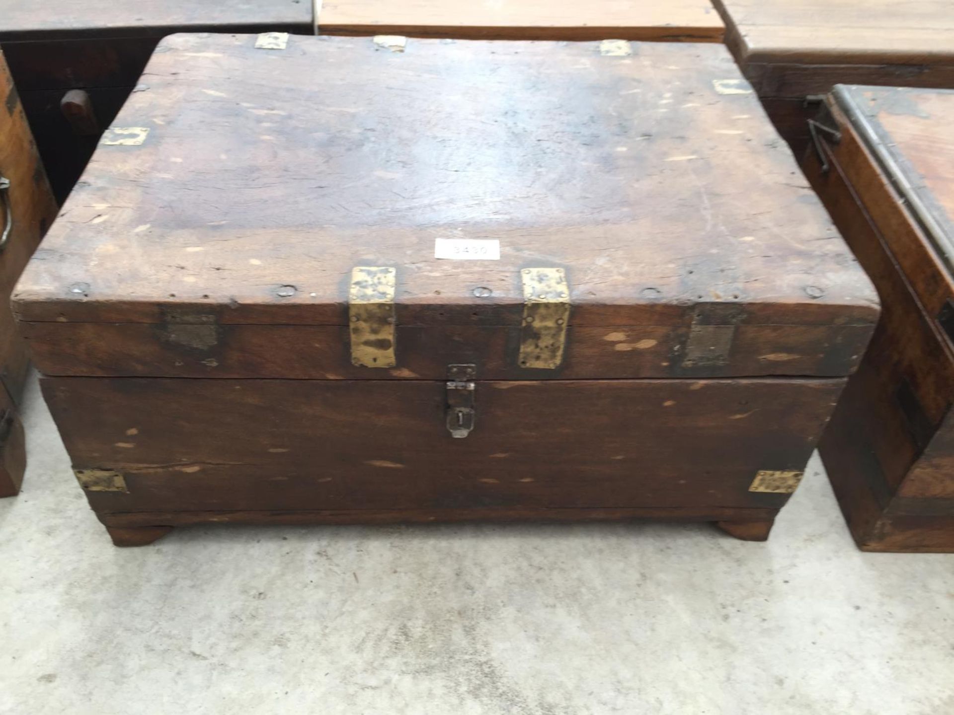 AN INDIAN HARDWOOD BOX WITH BRASS CLASP + DECORATION, 19" WIDE