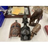 FOUR CARVED AFRICAN STYLE WOODEN FIGURES TO INCLUDE A BUST OF A LADY, A MASK, RHINO AND DEER