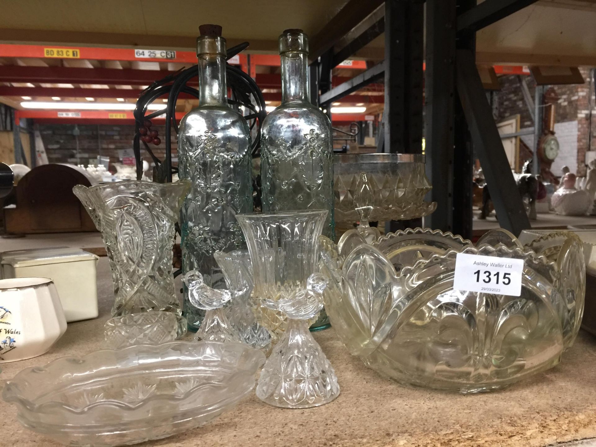 A QUANTITY OF GLASSWARE TO INCLUDE BOWLS, VASES, BOTTLES, ORNAMENTS TOGETHER WITH A BOTTLE RACK