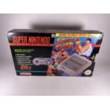 A BOXED RETRO SUPER NINTENDO STREET FIGHTER II ENTERTAINMENT SYSTEM CONSOLE