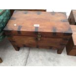 AN INDIAN HARDWOOD BOX ON LEGS WITH METALWORK FITTINGS, 18" WIDE