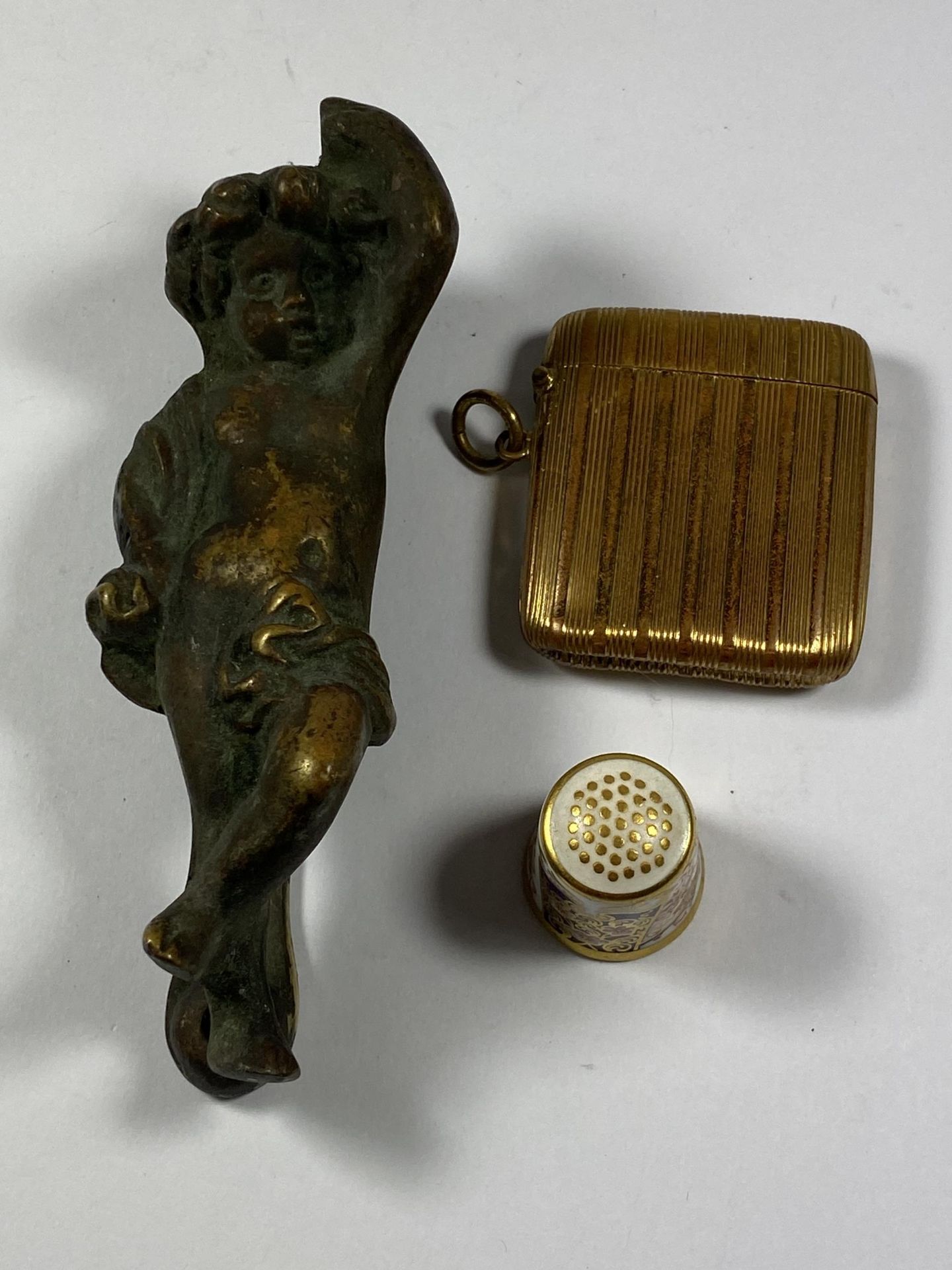 A GROUP OF THREE ITEMS - ROYAL CROWN DERBY THIMBLE, BRASS VESTA CASE AND VICTORIAN FIGURAL DOOR