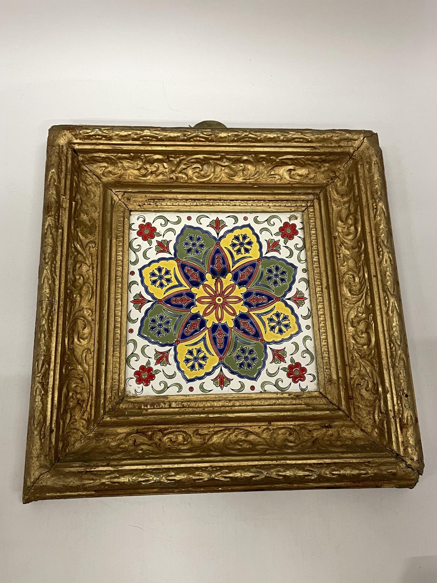 A DECORATIVE GILT FRAMED POSSIBLY LONGWY FRENCH POTTERY TILED PLAQUE