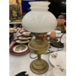 A VINTAGE BRASS OIL LAMP WITH OPAQUE SHADE