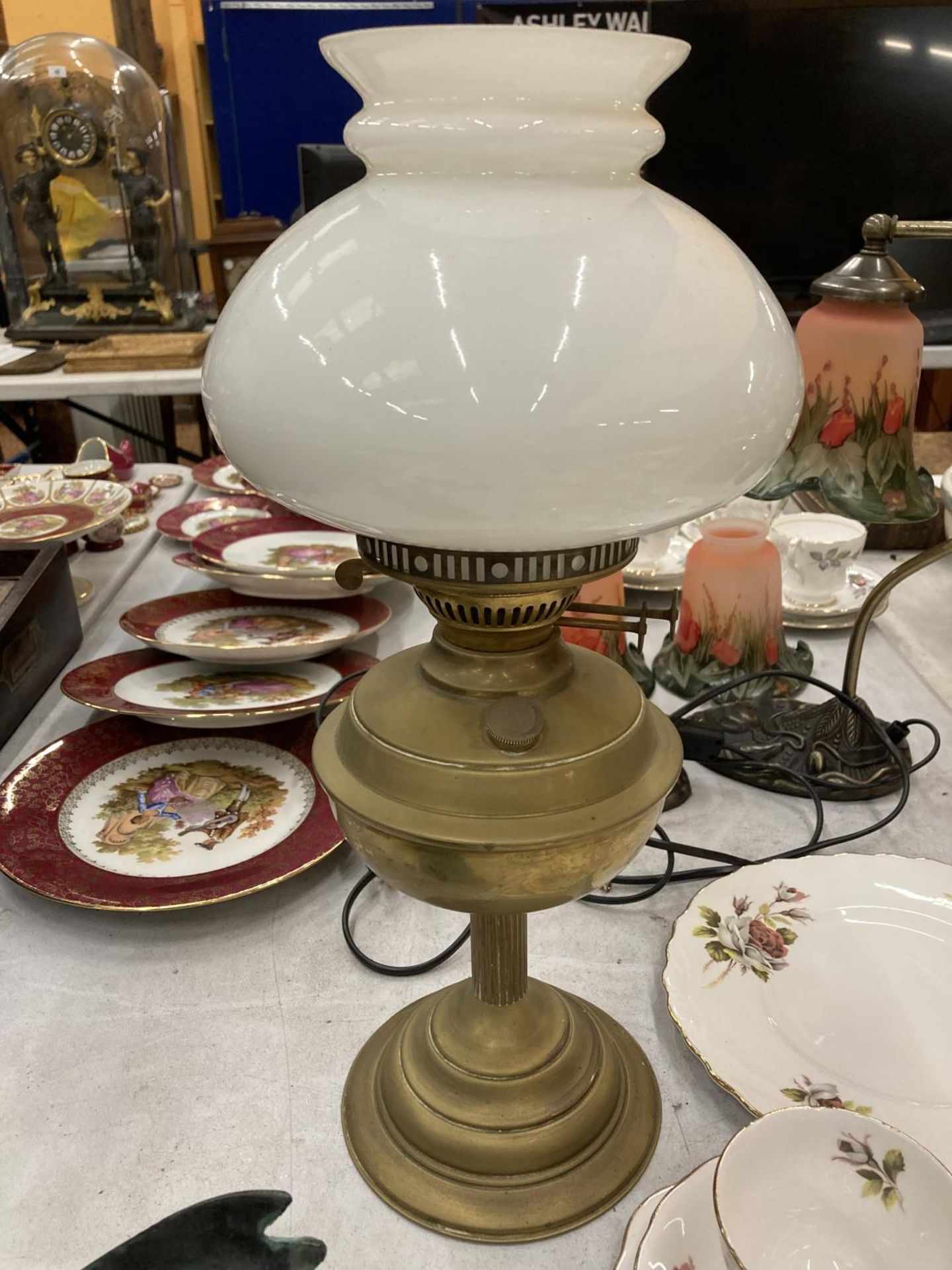 A VINTAGE BRASS OIL LAMP WITH OPAQUE SHADE