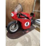 A HONDA RC166 MODEL FAIRGROUND RIDE MOUNTED ON A WOODEN PLINTH