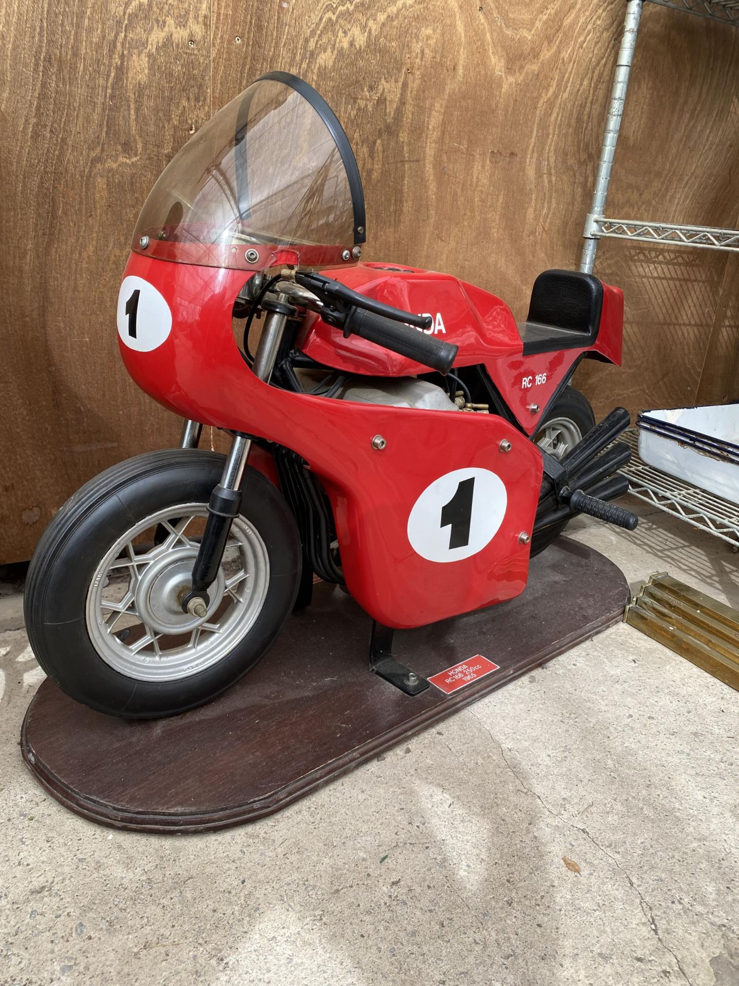 A HONDA RC166 MODEL FAIRGROUND RIDE MOUNTED ON A WOODEN PLINTH