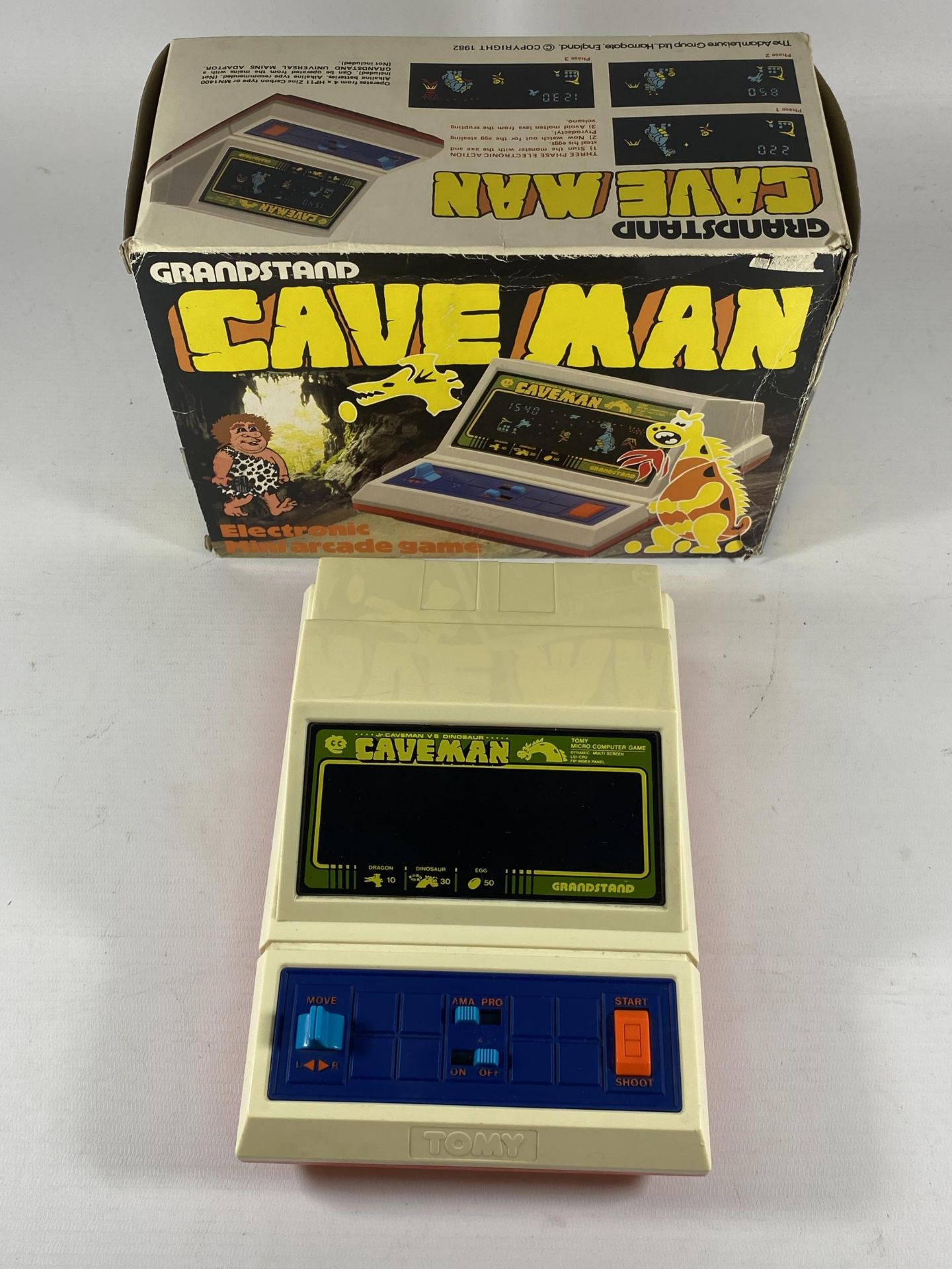 A RETRO BOXED GRANDSTAND CAVE MAN ELECTRONIC MINI ARCADE GAME