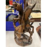 A HARDWOOD SCULPTURE OF FIGHTING HORSES