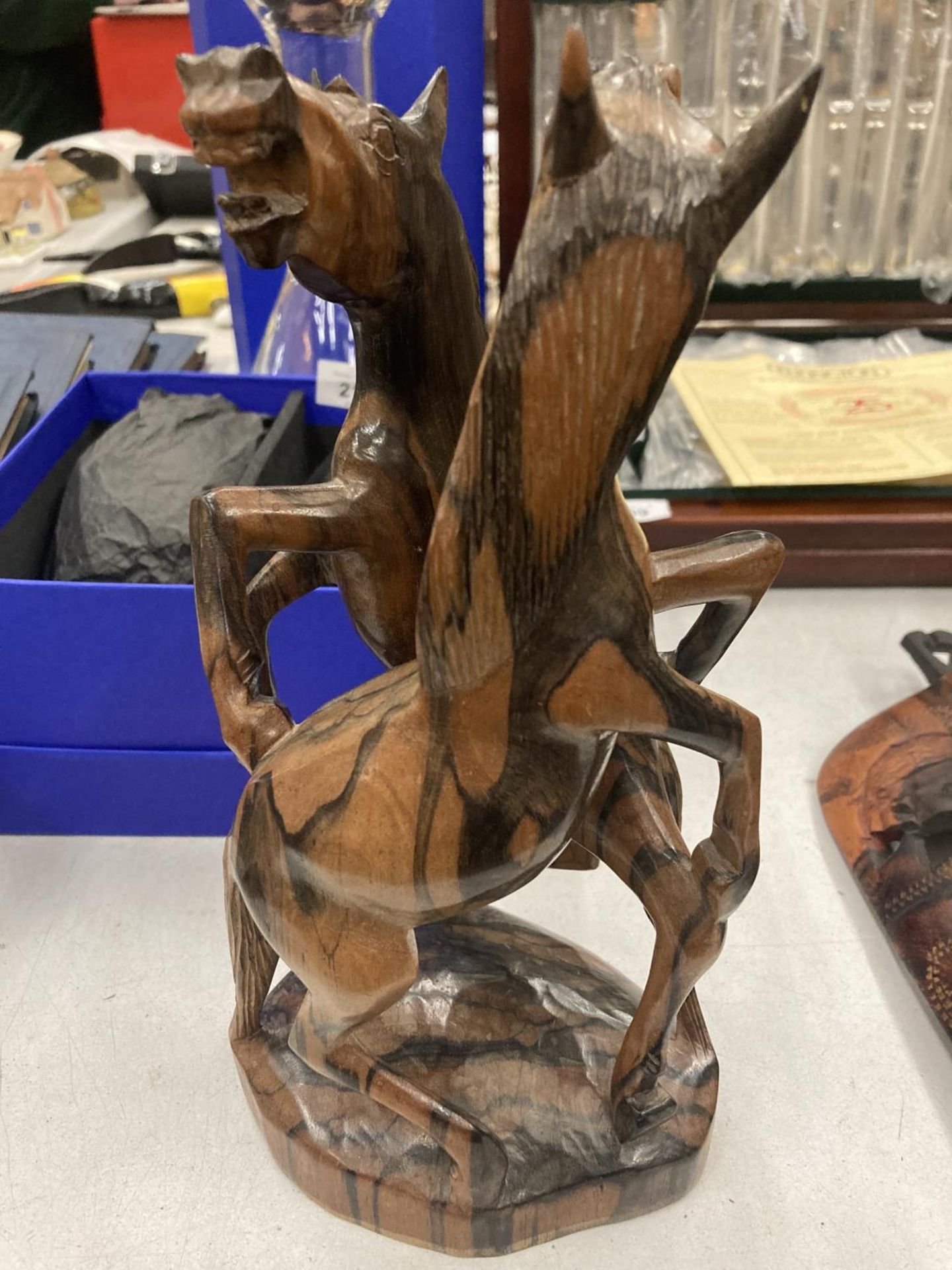 A HARDWOOD SCULPTURE OF FIGHTING HORSES