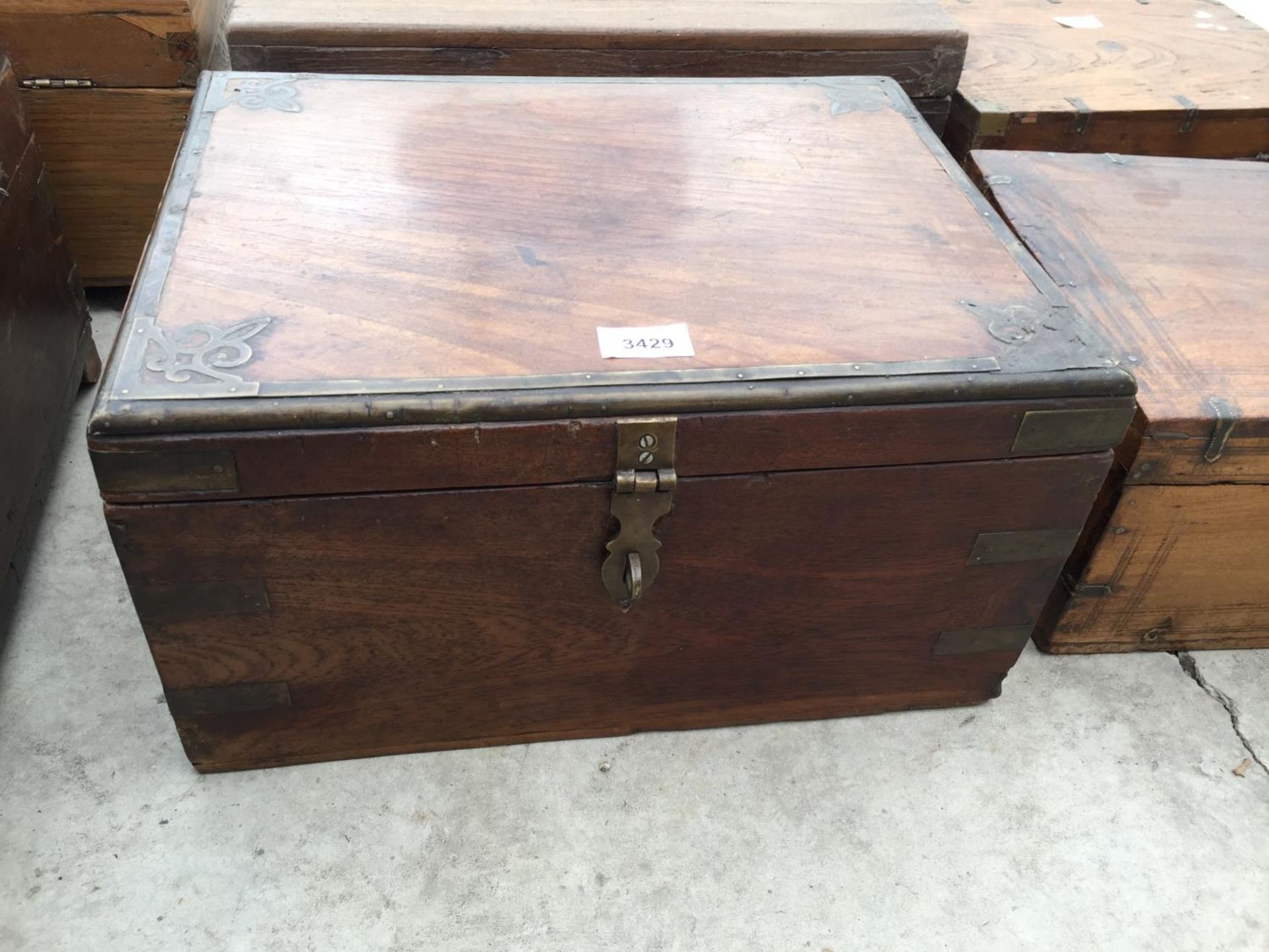 AN INDIAN HARDWOOD BOX WITH BRASS CLASP + DECORATION, 16" WIDE