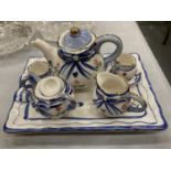 A MINIATURE CERAMIC TEASET ON A TRAY