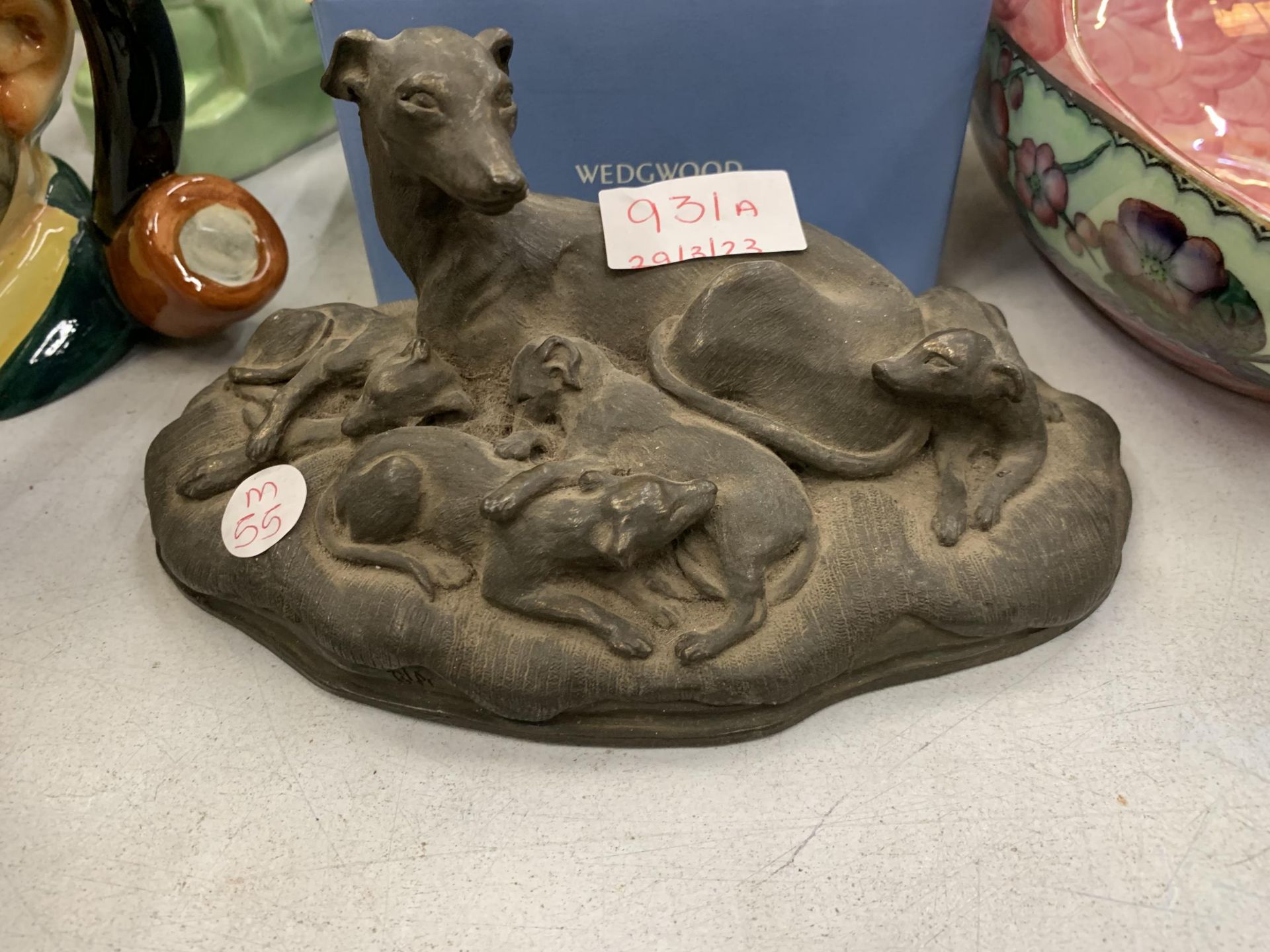 A STONEWARE MODEL OF A GREYHOUND AND PUPS HEIGHT 11CM, LENGTH 22CM