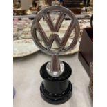 A CHROME VW LOGO ON A BASE HEIGHT 22CM