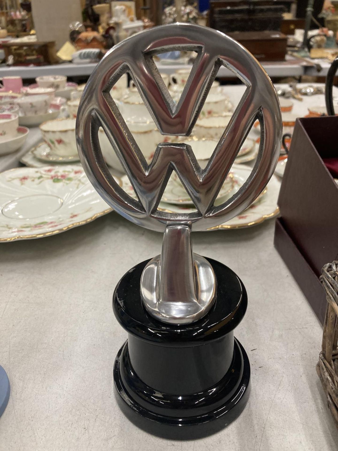 A CHROME VW LOGO ON A BASE HEIGHT 22CM