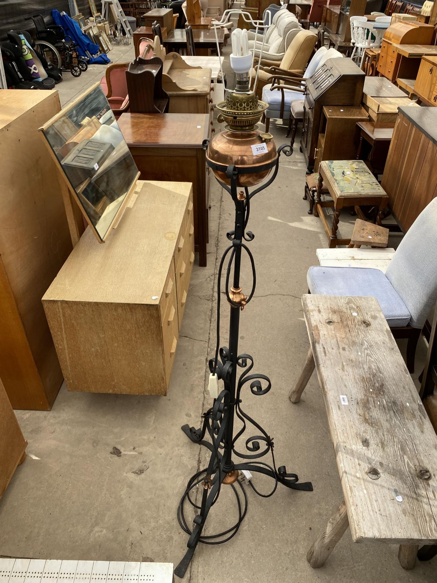 A BLACK WROUGHT IRON AND COPPER OIL STANDARD LAMP, CONVERTED TO ELECTRICITY