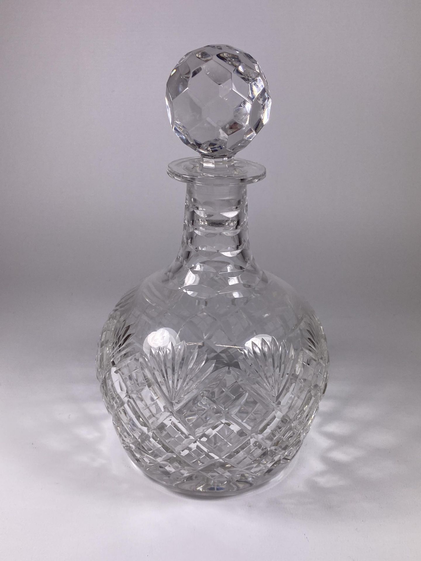 A ROYAL DOULTON CUT GLASS DECANTER