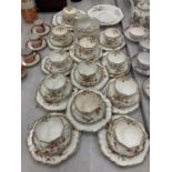 AN ANTIQUE DIAMOND CHINA TEASET TO INCLUDE A LARGE NUMBER OF TRIOS, TWO CAKE PLATES, A CREAM JUG AND