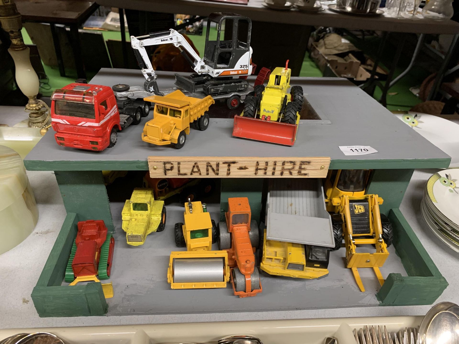 A PLANT HIRE GARAGE WITH TWELVE VARIOUS VEHICLES AND MACHINES