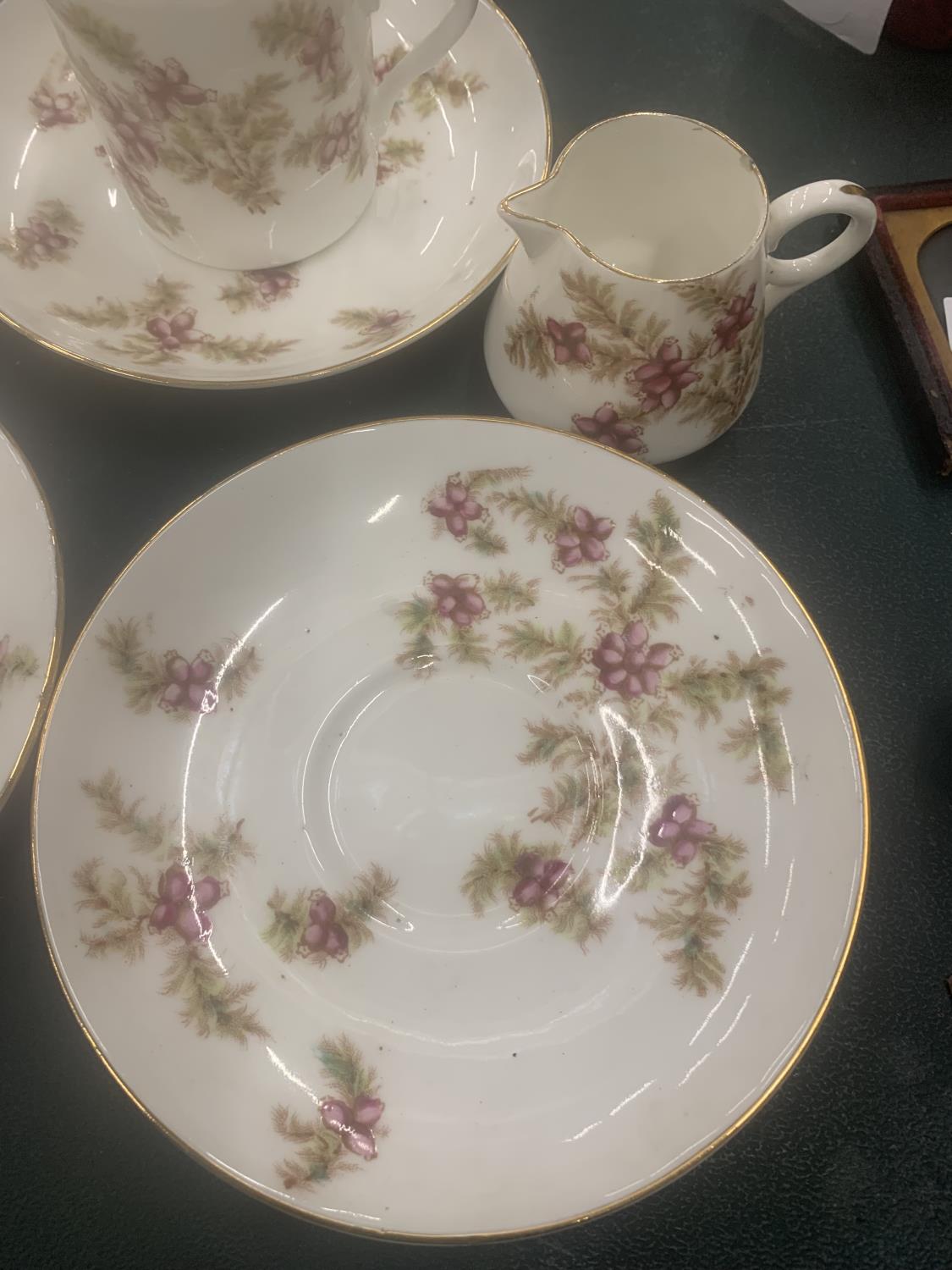 A VINTAGE CHINA PART TEASET WITH PINK FLORAL PATTERN TO INCLUDE CUPS, SAUCERS, CREAM JUG AND A SUGAR - Image 3 of 4