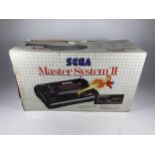 A BOXED RETRO SEGA MASTER SYSTEM II GAMING CONSOLE