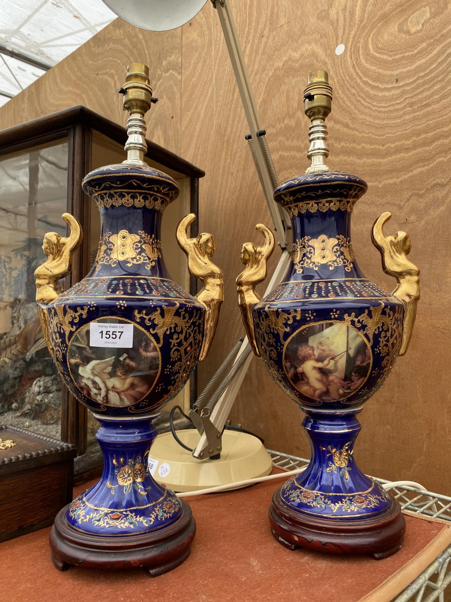 A PAIR OF BLUE CERAMIC ORIENTAL STYLE TABLE LAMPS WITH CHERUB DESIGN