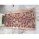 AN INDIAN HARDWOOD CARVED PANEL 29 X 17"