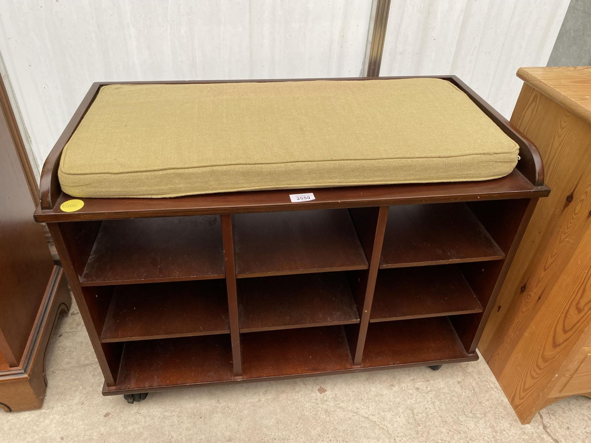 A MODERN NINE DIVISION OPEN STORAGE UNIT WITH CUSHION TOP, 31" WIDE