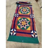 A LARGE FABRIC WALL HANGING - APPROX 12FT LONG