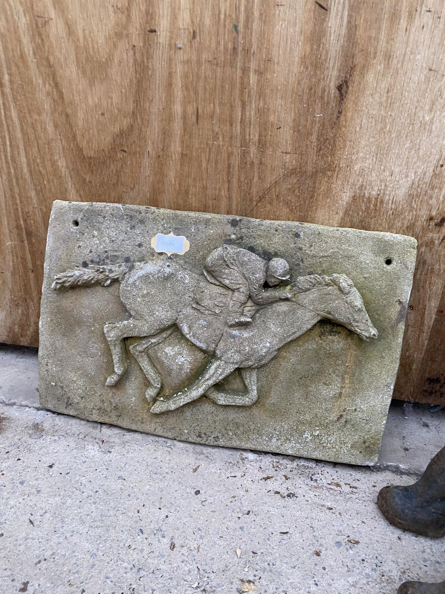 A STONE HORSE AND JOCKEY PLAQUE SIGN