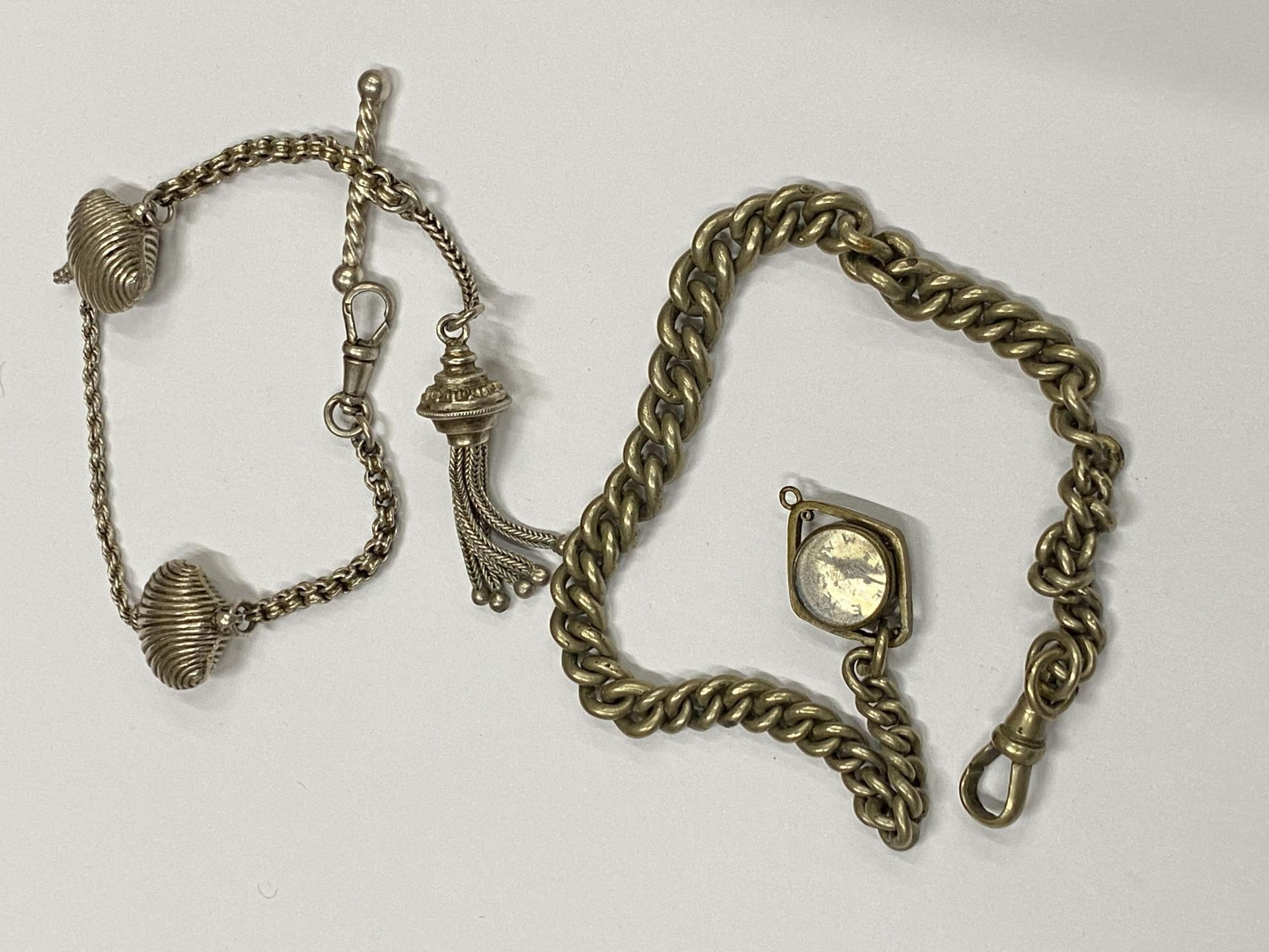 TWO VINTAGE SILVER PLATED ALBERT CHAINS TO INCLUDE A FANCY SHELL DESIGN EXAMPLE