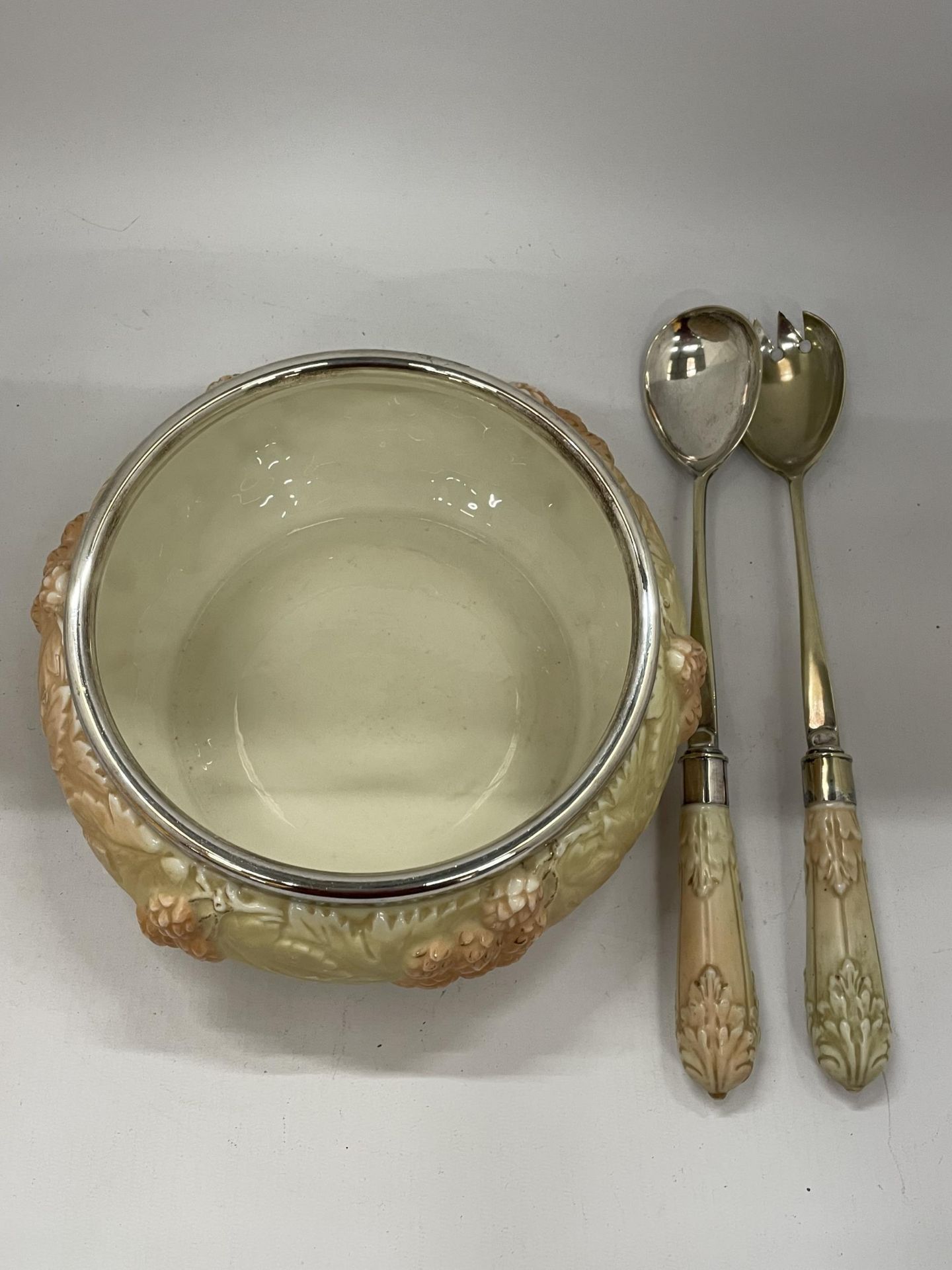 A VINTAGE BLUSH IVORY CERAMIC BOWL WITH SILVER PLATED RIM AND MATCHING SALAD SERVERS