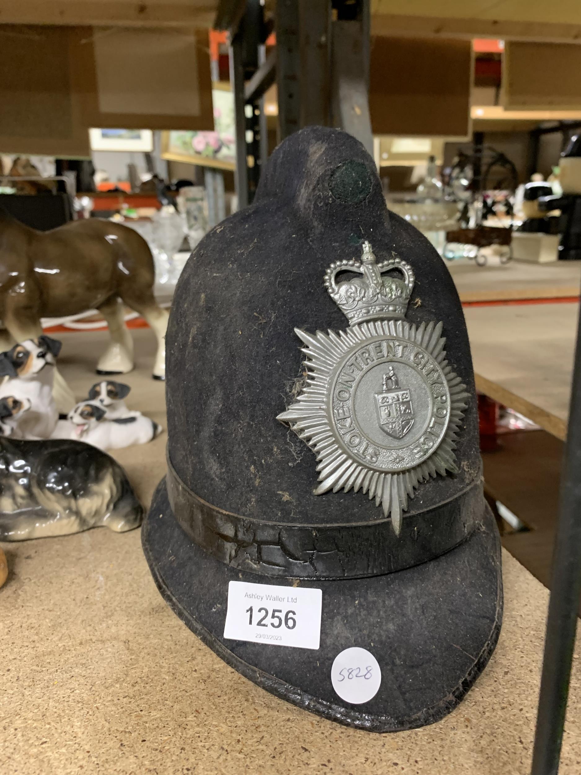 A VINTAGE STOKE ON TRENT CITY POLICE HELMET WITH PLATE