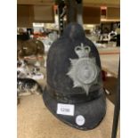 A VINTAGE STOKE ON TRENT CITY POLICE HELMET WITH PLATE