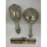 A GEORGE V SILVER BACKED THREE PIECE DRESSING SET COMPRISING HAND MIRROR, BRUSH AND COMB